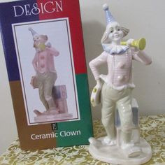 a ceramic figurine is next to a book