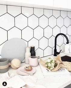 the kitchen counter is cluttered with dishes and utensils