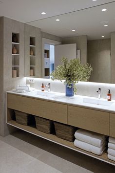 a large bathroom with two sinks and towels on the counter top in front of it