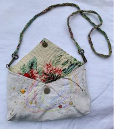 a white purse with floral designs on it