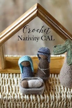 two crochet nativity baby booties sitting next to each other in front of a house