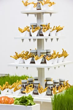 there is a three tiered display with food on it