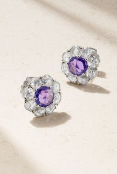 Bayco's earrings are handmade from platinum in the shape of dainty blooms. They're centered with purple sapphires framed by 3.10-carats of diamonds - both varieties of stones have unique rose-cuts that let the color and light really shine through. White Gold Tanzanite Earrings With Brilliant Cut, Silver Tanzanite Earrings For Wedding, Lavender Fine Jewelry Earrings For Formal Occasions, Formal Lavender Fine Jewelry Earrings, Elegant Lavender Flower Shaped Jewelry, Platinum Diamond Earrings In White Gold, White Gold Diamond Earrings In Platinum, White Gold Diamond Earrings With Gemstones In Platinum, Silver Diamond Cluster Earrings With Gemstone