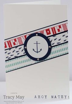 a close up of a card with an anchor on the front and stripes on the back