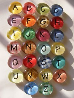 the letters and numbers are made up of glass stones with different colors, shapes and sizes