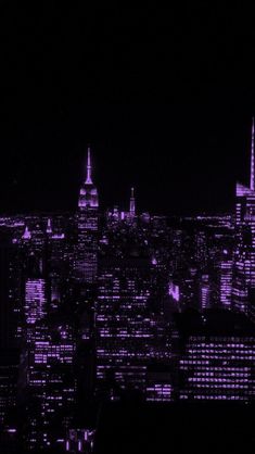 the city skyline is lit up at night with purple lights and skyscrapers in the background