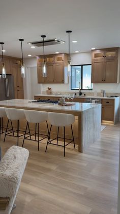 a kitchen with wooden floors and white counter tops