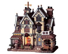 a toy house with lights and decorations on it