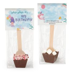 two wooden spoons with marshmallows in them