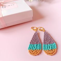 Beautiful handmade Turquoise mauve & gold teardrop earrings. These multicolor seed beaded earrings are made with high-quality seed beads and gold-plated lever backs, so if you like them, click Add to cart, and we will prepare them for you. Item description: Measures:  Length: 2 1/4 Width: 3/4 inch Materials:  -Czech seed beads -Gold Plated lever backs Shipping: These earrings will be ship the same day or the next business day. Package includes: -One pair of earrings -Paper Wrapping -Hand letter Dangle Teardrop Earrings With Tiny Beads As Gift, Gift Teardrop Dangle Earrings With Tiny Beads, Summer Beaded Teardrop Jewelry, Teardrop Earrings With Tiny Beads For Gift, Unique Teardrop Jewelry With Colorful Beads, Unique Teardrop-shaped Jewelry With Colorful Beads, Beaded Teardrop Earrings As Gift, Beaded Teardrop Earrings For Gift, Handmade Long Drop Beaded Earrings As Gift