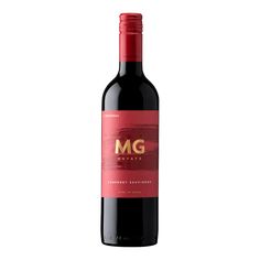 a bottle of red wine with the word m g on it and a gold emblem