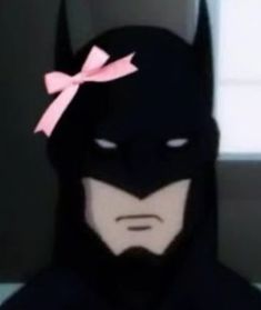 a batman with a pink bow on his head