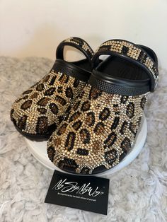 MyStyleMyWay's  custom crocs are designed for the perfect outfit, that special occasion, and "Just Because" you love blinged out crocs.  In the display shown we designed a pair of black "Cheetah Print Design" classic crocs adding high quality colorful rhinestones. 🐆Each Rhinestone is individually and neatly placed to achieve the design.  🐆Rhinestones are added to the top and buttom trimming of the shoe.  🐆This design was personalized. 🐆The sports mode strap is also designed.   🐆This design do not have charms or patches. charms can be added please contact us directly to discuss charm options.  🐆When making your purchase - You're making a purchase for the exact style shown. If you would like a different color rhinestone,  and or different charms please message us so we can assist you. Blinged Out Crocs, Bedazzled Crocs, Cheetah Print Design, Womens Clogs And Mules, Custom Crocs, Classic Crocs, Bling Design, Custom Bling, Clogs And Mules