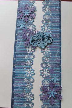 a handmade card with snowflakes on the side and a name tag attached to it