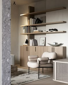 a living room filled with furniture and bookshelves next to a wall mounted book shelf