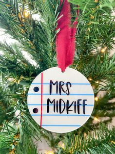 a christmas ornament that says mrs midwife hanging from a tree with red ribbon