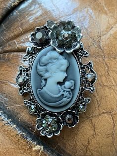 Portrait of a Lady Cameo Brooch. This lovely brooch has been stored in my jewellery box for years and bought it at a festival. This is a beautiful and sparkly one off brooch and is as good as new. Estimated Length 5.5cm Estimated Width 3.8cm Antique Style Pins As Gifts, Victorian Antique Silver Brooch, Victorian Style Brooches For Gift, Victorian Antique Silver Brooch For Gift, Victorian Antique Silver Brooches As Gift, Silver Victorian Pins, Victorian Antique Silver Wedding Brooches, Antique Silver Vintage Brooches As Gift, Silver Costume Jewelry Pins