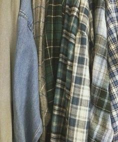 an assortment of shirts hanging on a rack