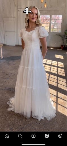 a woman wearing a white dress with ruffles on it