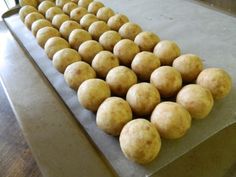 several balls of dough sitting on top of a baking sheet