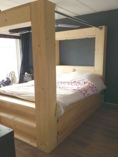 a bed that is made up with wooden posts