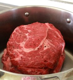 a raw steak in a pot with seasoning on the top and bottom, ready to be cooked