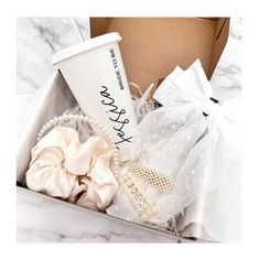 a coffee cup and some hair accessories in a box