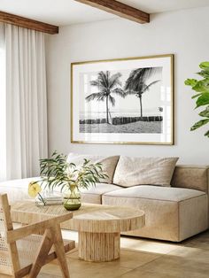 a living room filled with furniture and a painting on the wall