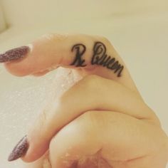 a woman's left hand with the word runn tattooed on her thumb and finger