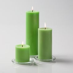 three green candles sitting next to each other