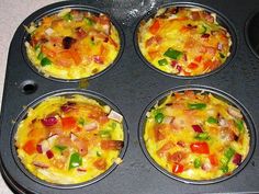 four muffin tins filled with breakfast food on top of a counter next to an oven