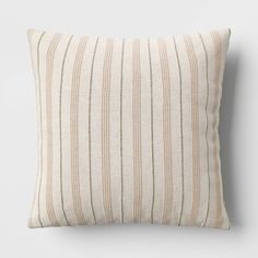 a striped pillow on a white wall