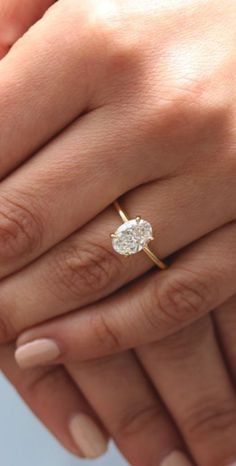 a woman's hand with a diamond ring on it