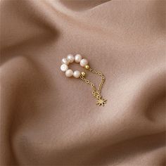 Finish your look with this dreamy ear cuff offering a row of shimmering pearls and a star charm accent that hangs from a delicate 18k gold-plated chain. Includes one ear cuff 0.63" W x 1.73" L 18k gold-plated copper / pearl Fairy Earrings, Tassel Earing, Copper Pearl, Cat Bow, Kawaii Jewelry, Star Chain, Charm Chain, Bow Earrings, Lipstick Makeup