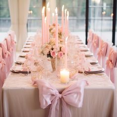 the table is set with candles and flowers