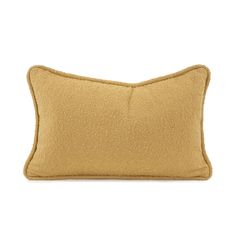 a tan pillow on a white background