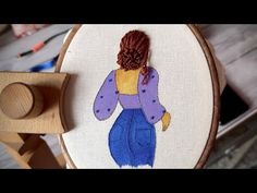 a woman's head is seen through the embroidery