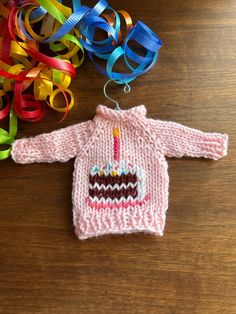 a knitted sweater with a birthday candle on it