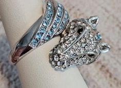 HOT TO TROT by Park Lane.  The horse wraps around your finger, with powder blue, crystal-encrusted face on one end and it`s tail on the other. *Hypoallergenic *Lead & Nickel free NWOT. Never worn. No scuffs, no missing stones. Excellent condition and quality.  Retails new over $65! #WearItAgainLove #preowned #preloved #jewelry #fashion #statement #accessories #beyourself #recycled **NOTE: When placing orders, please put all items needed together in one order. Due to shipping labels and tracking, Park Lane Jewelry Rings, Park Lane Rings, Horse Ring, Statement Accessories, Shipping Label, Shipping Labels, Park Lane, The Horse, Ladies Fashion