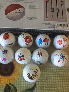 the golf balls have been decorated with images of animals and flowers on them, including ladybugs