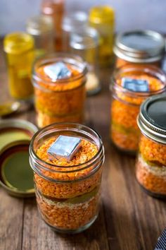 jars filled with food sitting on top of a wooden table