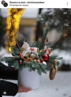 a person holding a christmas decoration in their hand