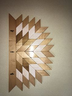 a clock made out of wooden strips on the wall