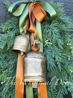 a christmas wreath with bells hanging from it