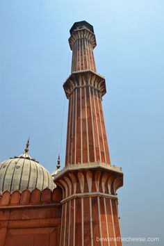 a tall brick building with a dome on top