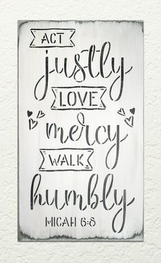 a wooden sign with the words, act justly love and mercy walk rumbly