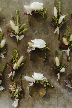 wedding boutions with white flowers and greenery