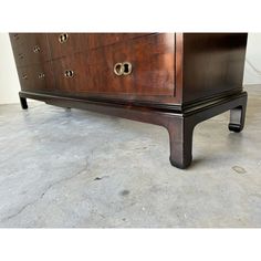 a large wooden dresser sitting on top of a cement floor