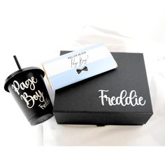 two coffee mugs sitting next to each other on top of a black gift box