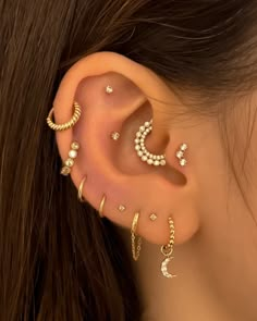 a woman wearing ear piercings with pearls